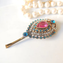 Decorative hairpin with gemstones on a white background

